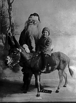 Santa hears child's wishes in Oak Park circa 1900